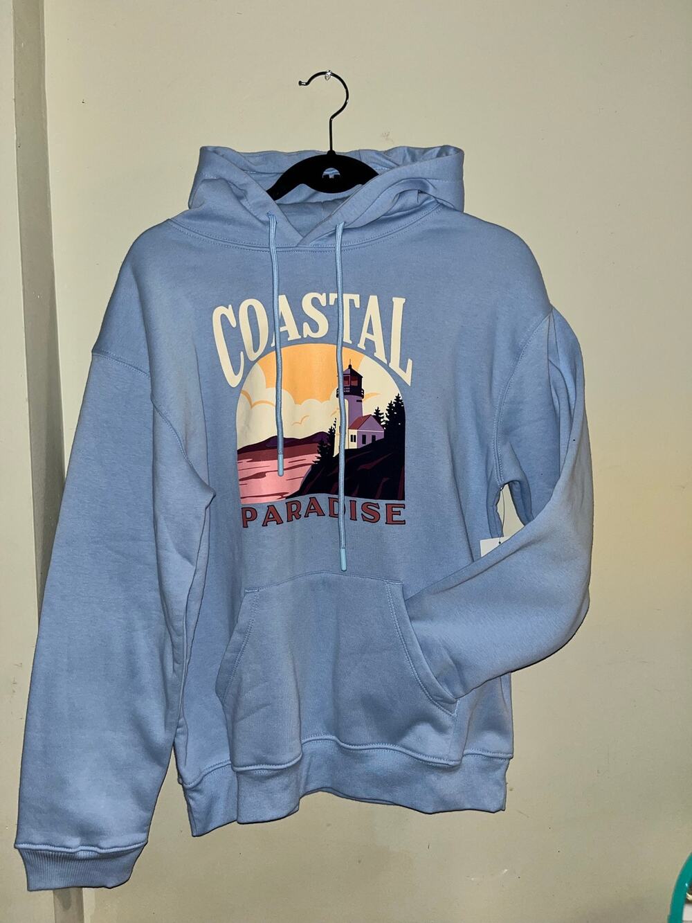 The Easygoing Co Women’s Small Blue Coastal Paradise Lighthouse Graphic Hoodie